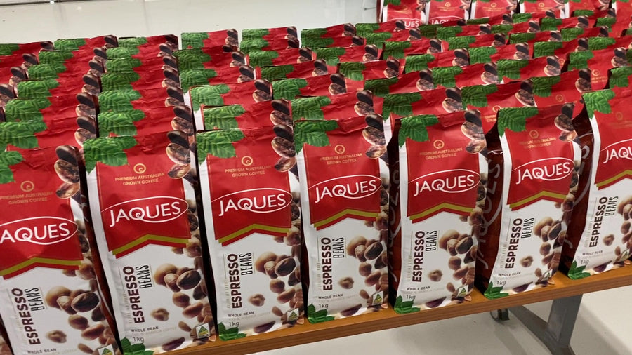 Rows of red Jaques Coffee bags packed and ready for sale